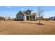 Charming two-story home with well-kept landscaping and a young sapling in the front yard at 8217 Cannon Grove Dr, Willow Springs, NC 27592