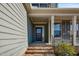 Welcoming front entrance showcasing a cozy porch and tasteful architectural details, enhancing curb appeal at 8217 Cannon Grove Dr, Willow Springs, NC 27592