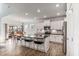 Modern kitchen features an island with bar seating, stainless steel appliances, and a dining area at 8217 Cannon Grove Dr, Willow Springs, NC 27592