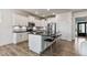 Well-appointed kitchen with white cabinetry, a stylish island, and modern stainless-steel appliances at 8217 Cannon Grove Dr, Willow Springs, NC 27592