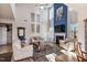 Bright living room with high ceilings, a fireplace, and large windows creating a welcoming atmosphere at 8217 Cannon Grove Dr, Willow Springs, NC 27592