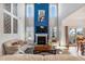 Spacious living room featuring a fireplace and tall windows, offering plenty of natural light and elegant decor at 8217 Cannon Grove Dr, Willow Springs, NC 27592