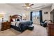 Bedroom featuring tray ceilings, a ceiling fan, a large bed, and a window at 8217 Cannon Grove Dr, Willow Springs, NC 27592