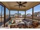 Relax on the screened porch with a ceiling fan and comfortable seating to enjoy the backyard view at 8217 Cannon Grove Dr, Willow Springs, NC 27592