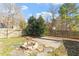 Landscaped backyard with fire pit and patio area at 101 Stefi Ct, Garner, NC 27529