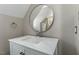 Small bathroom with vanity and round mirror at 101 Stefi Ct, Garner, NC 27529