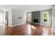 Bright living room featuring hardwood floors, a fireplace, and large windows at 101 Stefi Ct, Garner, NC 27529