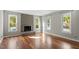 Living room with hardwood floors, fireplace, and multiple windows offering natural light at 101 Stefi Ct, Garner, NC 27529
