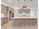 Bright kitchen features a large island with pendant lighting and stainless steel appliances at 200 Regency Ridge Dr, Holly Springs, NC 27540