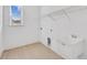 Bright laundry room featuring built-in shelving and utility sink at 200 Regency Ridge Dr, Holly Springs, NC 27540