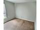 Simple carpeted bedroom with window and neutral walls at 250 S Estes Dr # Apt 94, Chapel Hill, NC 27514