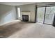 Living room with fireplace, carpet, and access to a deck at 250 S Estes Dr # Apt 94, Chapel Hill, NC 27514
