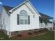 Side view of a single story home with white siding and brick base at 288 Rosa Cir, Willow Springs, NC 27592