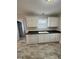 Bright kitchen with white cabinets, modern appliances, and tile flooring at 288 Rosa Cir, Willow Springs, NC 27592