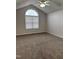 Main bedroom with vaulted ceiling and arched window at 288 Rosa Cir, Willow Springs, NC 27592