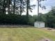 A large backyard with garden plots, a shed, and a wooden deck with fire pit at 317 Compton Rd, Raleigh, NC 27609