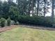 Wide backyard shot featuring a lush lawn and garden plots ready for planting at 317 Compton Rd, Raleigh, NC 27609