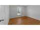 Spacious bedroom with hardwood floors and large window at 317 Compton Rd, Raleigh, NC 27609
