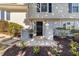 Front entrance with black door, brick columns, and landscaping at 317 Compton Rd, Raleigh, NC 27609
