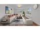 Bright living room features a large sectional sofa, modern art, and plenty of natural light at 317 Compton Rd, Raleigh, NC 27609
