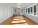 Bright living room with hardwood floors and large windows at 317 Compton Rd, Raleigh, NC 27609
