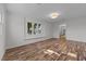 Bright living room with hardwood floors, leading to the staircase at 317 Compton Rd, Raleigh, NC 27609