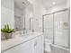 Sparkling clean bathroom with glass shower, white vanity and modern fixtures at 524 Billingshurst Way, Knightdale, NC 27545