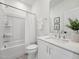 Well-lit bathroom with white vanity, tub and shower, and elegant decorative accents at 524 Billingshurst Way, Knightdale, NC 27545