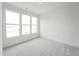 Bright bedroom features neutral carpet and plentiful sunlight from large windows at 524 Billingshurst Way, Knightdale, NC 27545