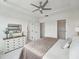 Bright bedroom with neutral decor, a ceiling fan, and access to an ensuite bath and walk-in closet at 524 Billingshurst Way, Knightdale, NC 27545