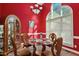 Bright dining room with glass table and red walls at 555 House Rd, Kenly, NC 27542