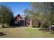 Red brick house with large windows and a lush green lawn at 555 House Rd, Kenly, NC 27542