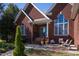 Brick front porch with seating area and landscaping at 555 House Rd, Kenly, NC 27542