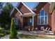 Brick front porch with seating area and landscaping at 555 House Rd, Kenly, NC 27542