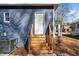 Charming back entrance featuring a white door with wooden stairs and blue siding at 835 Sunset Ave, Rocky Mount, NC 27804