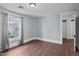 Well-lit bedroom featuring hardwood floors and an adjacent door at 835 Sunset Ave, Rocky Mount, NC 27804