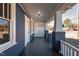 Spacious front porch with white railings and gray columns at 835 Sunset Ave, Rocky Mount, NC 27804