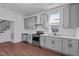 Modern kitchen with gray cabinets, stainless steel appliances, and white countertops at 835 Sunset Ave, Rocky Mount, NC 27804