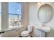Cozy bathroom with pedestal sink, oval mirror, and natural light at 851 Parc Townes Dr # 10, Wendell, NC 27591