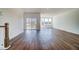 An open-concept living area with hardwood floors and sliding glass doors to a deck at 851 Parc Townes Dr # 10, Wendell, NC 27591