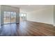 Spacious living room with hardwood flooring and sliding glass doors leading to the outdoor deck at 851 Parc Townes Dr # 10, Wendell, NC 27591