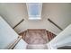 Looking down a carpeted staircase with white banisters and a skylight above at 851 Parc Townes Dr # 10, Wendell, NC 27591