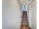 Carpeted staircase with white walls and a handrail in a home with natural light at 851 Parc Townes Dr # 10, Wendell, NC 27591