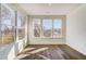 A sun-filled room features hardwood flooring and a wall of windows offering natural light at 851 Parc Townes Dr # 10, Wendell, NC 27591