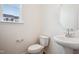 Bathroom features a classic white toilet and sink paired with a round mirror at 865 Parc Townes Dr # 4, Wendell, NC 27591