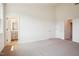 Bedroom with high ceilings, light carpet, and multiple entryways to adjoining rooms at 865 Parc Townes Dr # 4, Wendell, NC 27591