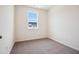 Bright bedroom with a large window offering natural light and neutral carpet at 865 Parc Townes Dr # 4, Wendell, NC 27591