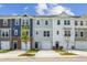 Charming new townhomes feature varied siding and attached garages with a sidewalk and small trees lining the street at 865 Parc Townes Dr # 4, Wendell, NC 27591