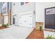 Two car garage with concrete driveway and stone accents at 865 Parc Townes Dr # 4, Wendell, NC 27591