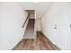 Hallway view of wood floors with stairs and doors leading to other rooms at 865 Parc Townes Dr # 4, Wendell, NC 27591